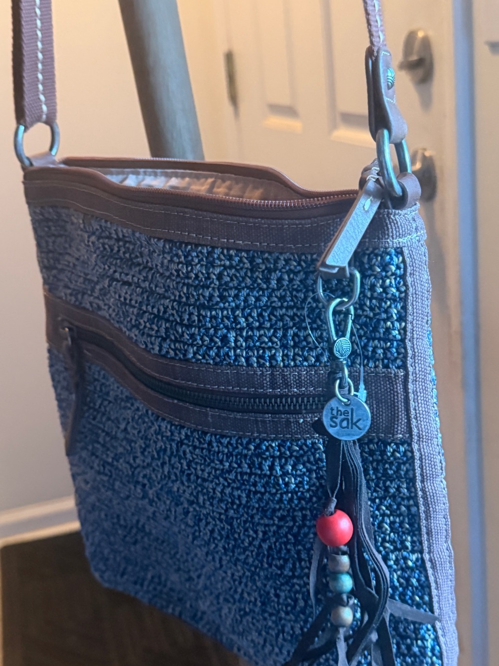 The Sak Navy Knit Crossbody Bag with Tassel Charm